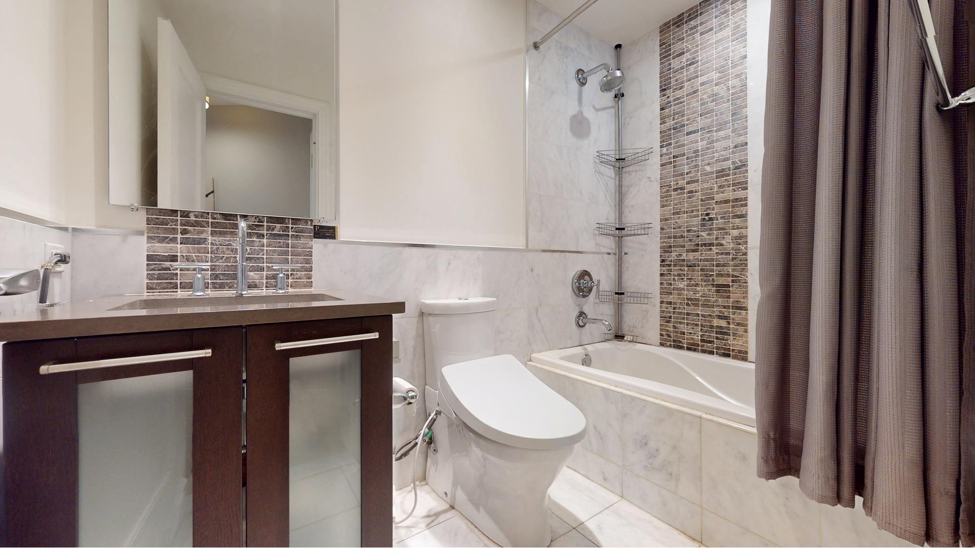 64-05 Yellowstone Boulevard, Unit TH105 Queens, NY 11375 - Photo 9 of 25 a bathroom with a sink a toilet and shower