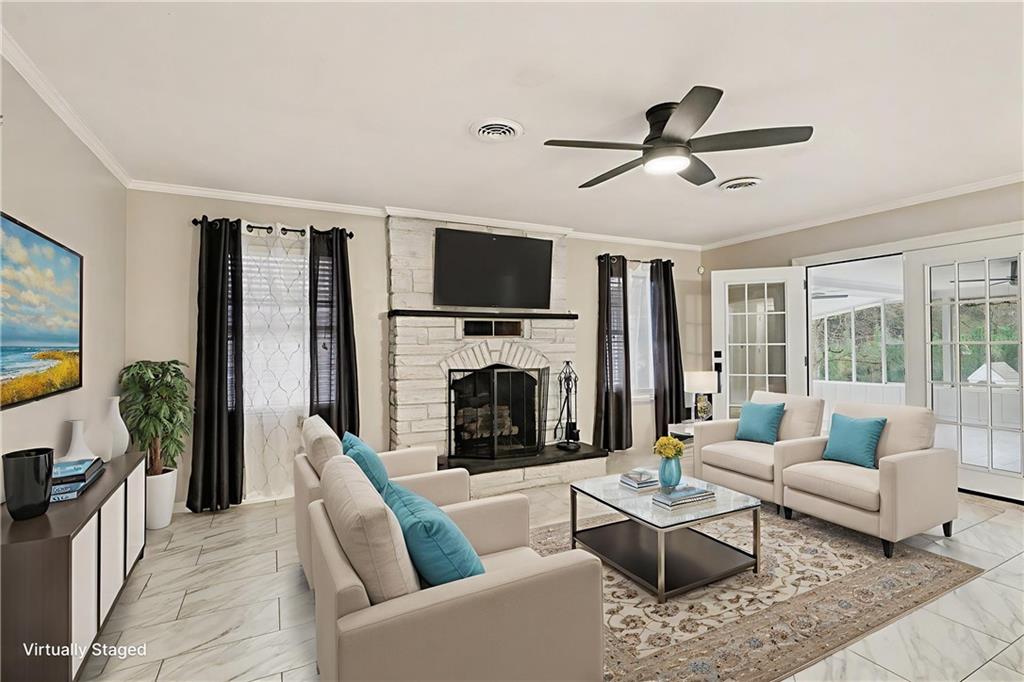 254 County Line Road Fayetteville, GA 30215 - Photo 14 of 51 a living room with furniture a fireplace and a flat screen tv