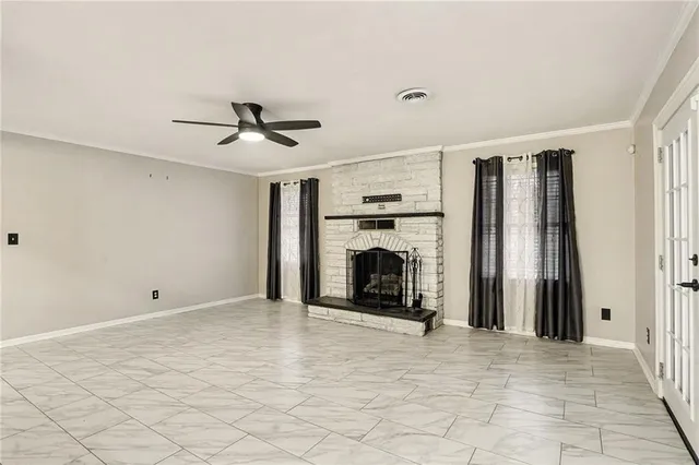 a view of a livingroom with a fireplace and a chandelier fan