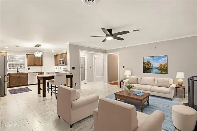 a living room with furniture and kitchen view