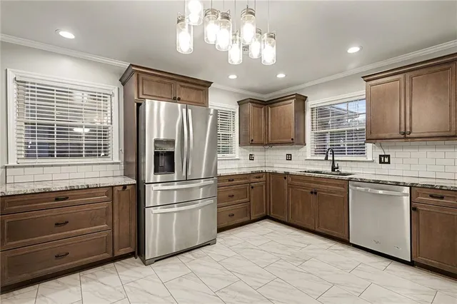 a kitchen with granite countertop stainless steel appliances cabinets a sink and a window
