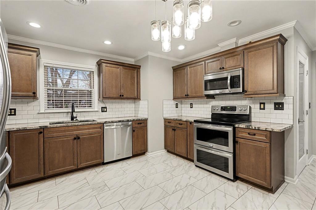 254 County Line Road Fayetteville, GA 30215 - Photo 22 of 51 a kitchen with stainless steel appliances granite countertop a stove top oven a sink dishwasher a dining table and chairs with wooden floor