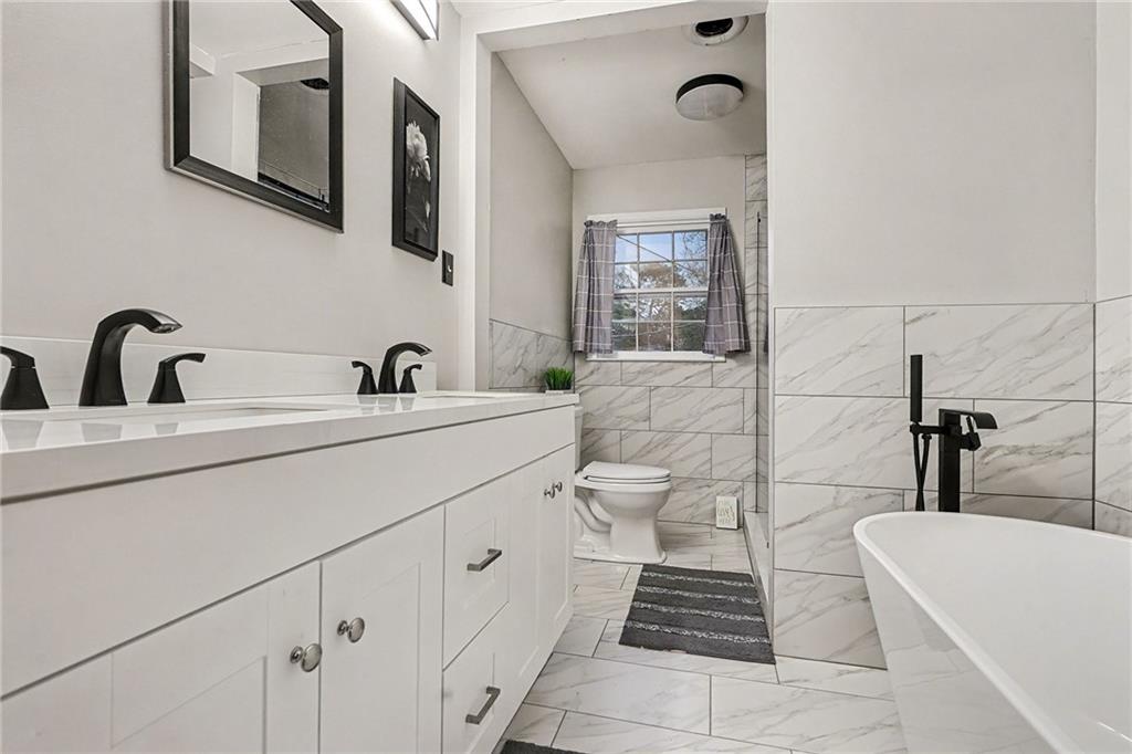 254 County Line Road Fayetteville, GA 30215 - Photo 27 of 51 a bathroom with a sink a toilet and a mirror