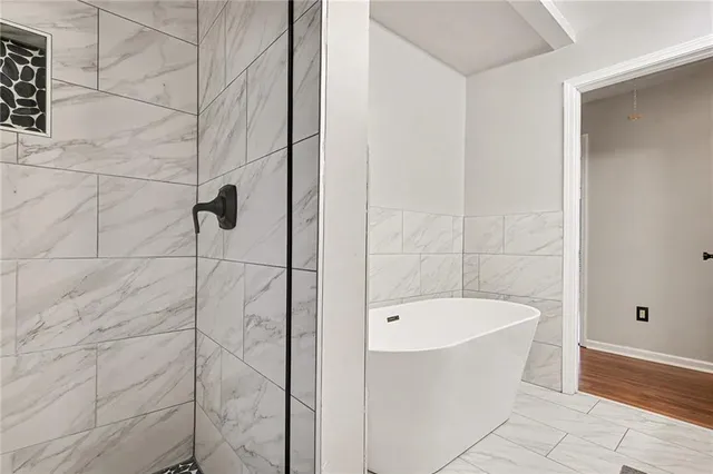a bathroom with a bathtub and shower