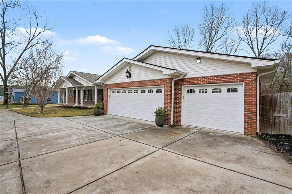 254 County Line Road Fayetteville, GA 30215 - Photo 3 of 51 a view of a house with a garage and large tree
