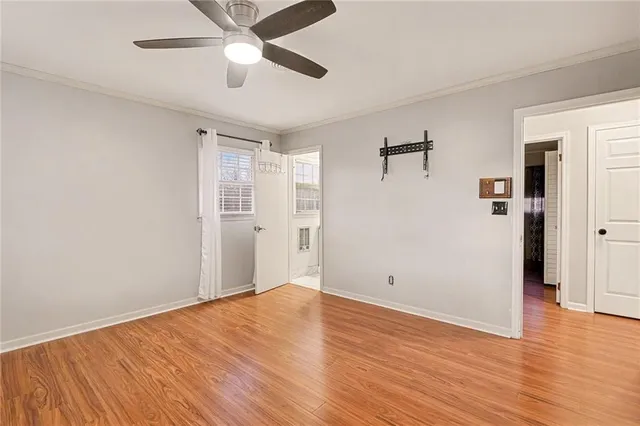 a view of empty room with wooden floor