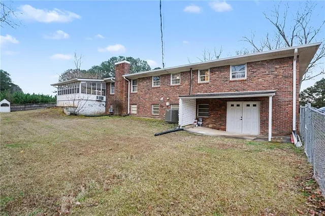 a view of a white house with a big yard and large tree