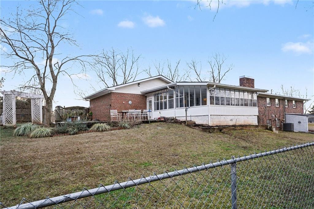 254 County Line Road Fayetteville, GA 30215 - Photo 47 of 51 a view of a white house with a big yard and large tree