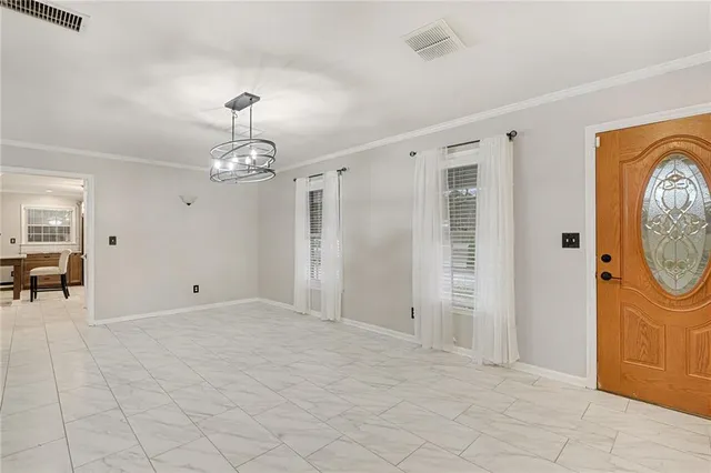 a view of a hallway with entryway dining table and chairs