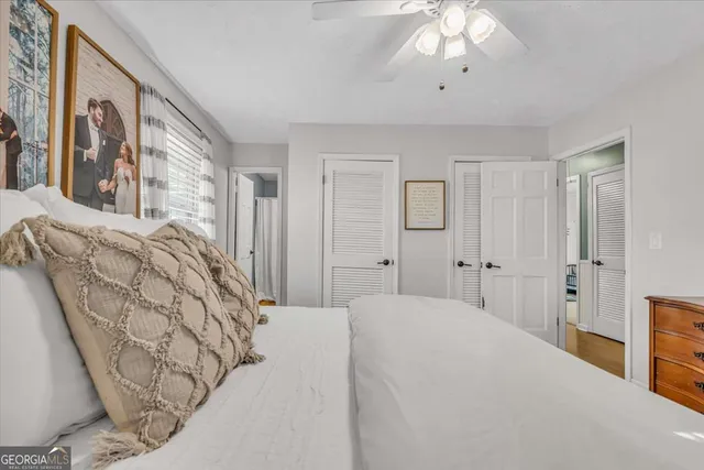 a bedroom with a large bed and a chandelier