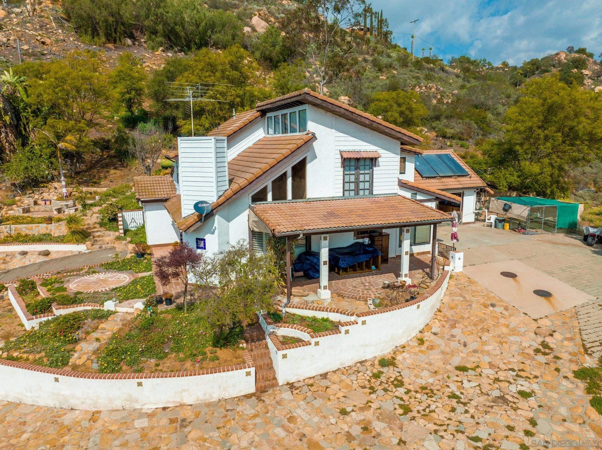 9202 Moon Ridge Road Fallbrook, CA 92028 - Photo 14 of 44 a view of a house with roof and sitting area