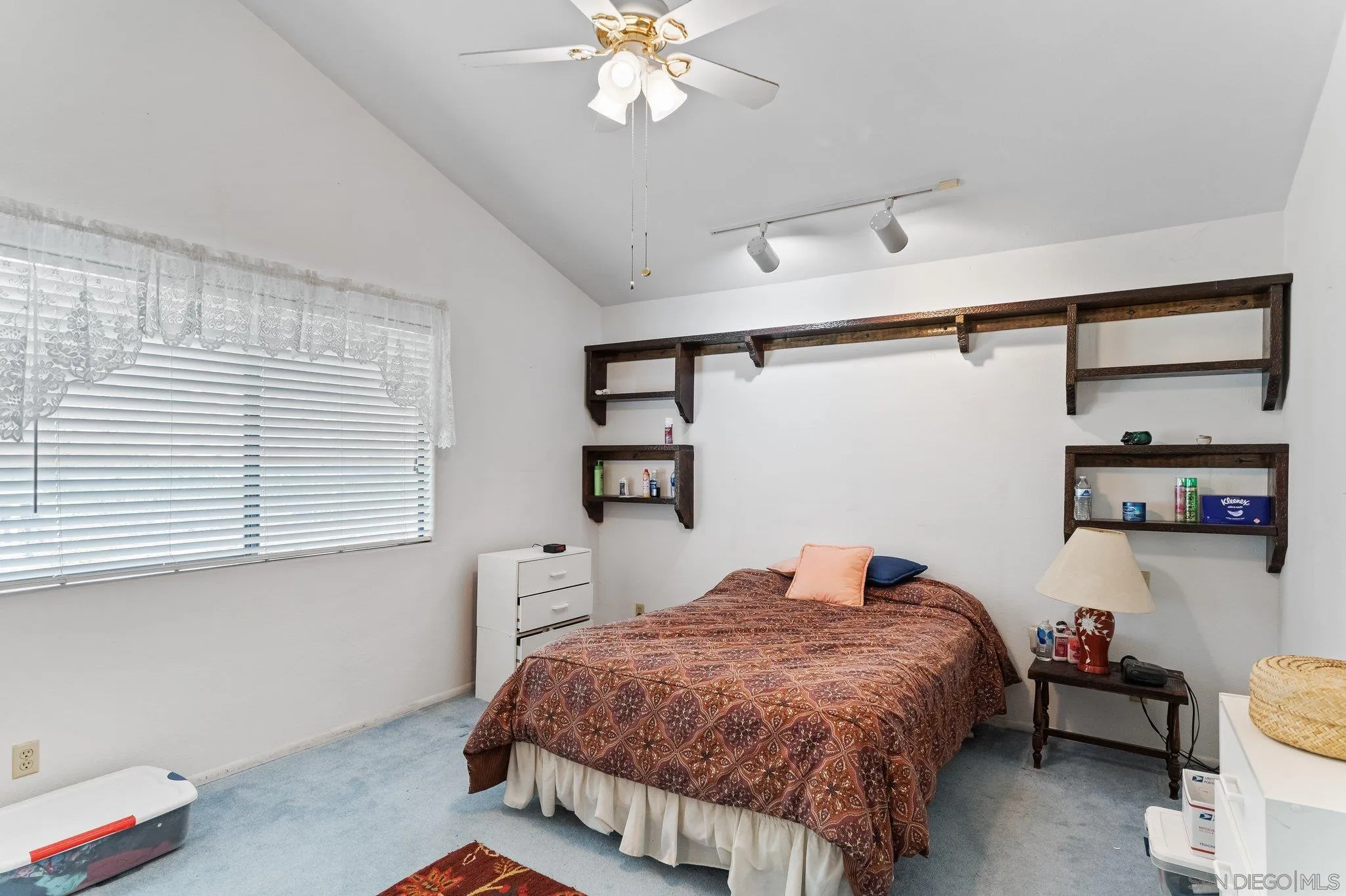 9202 Moon Ridge Road Fallbrook, CA 92028 - Photo 22 of 44 a bedroom with a bed and a chandelier