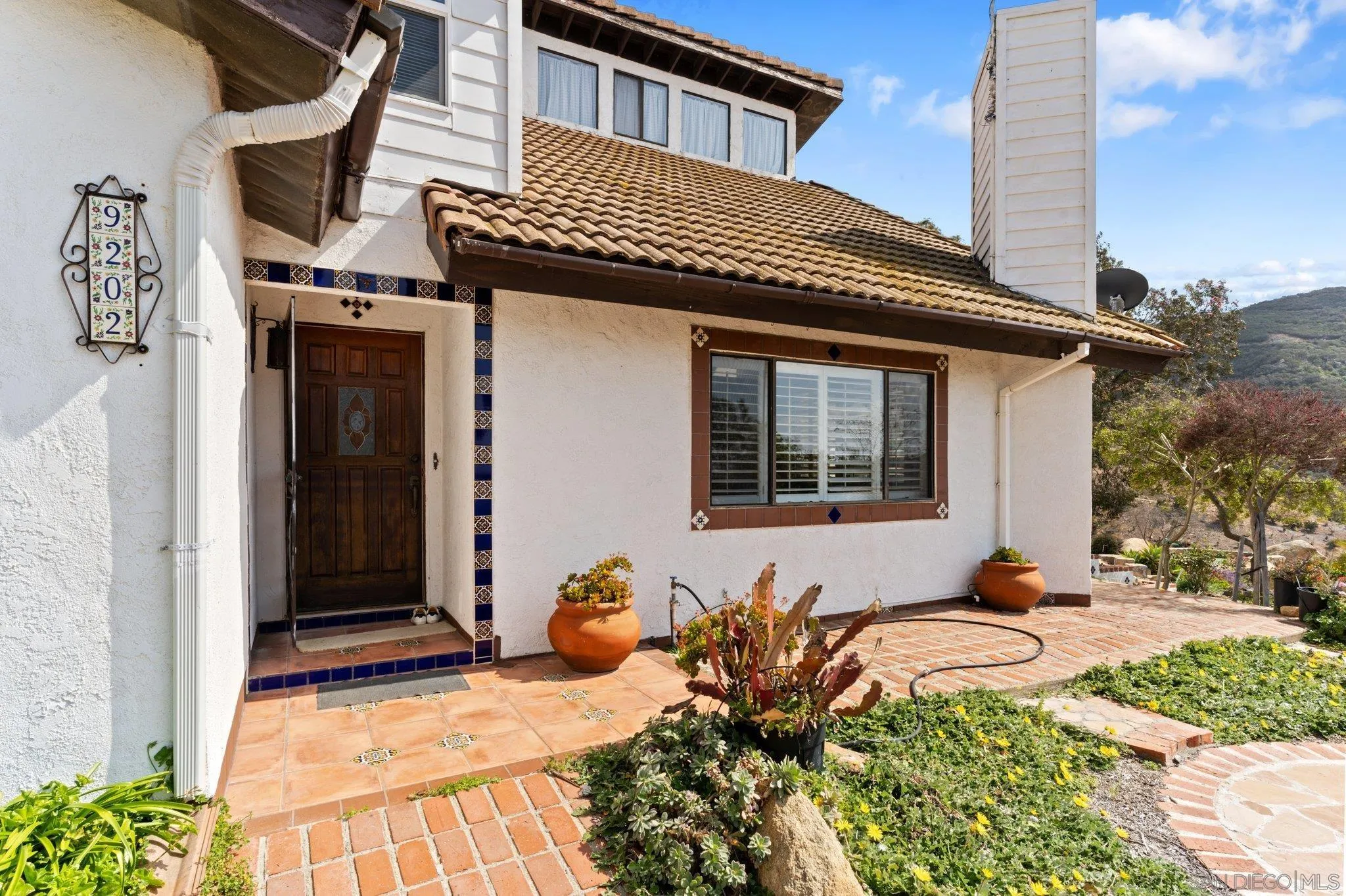 9202 Moon Ridge Road Fallbrook, CA 92028 - Photo 26 of 44 a front view of a house with a yard