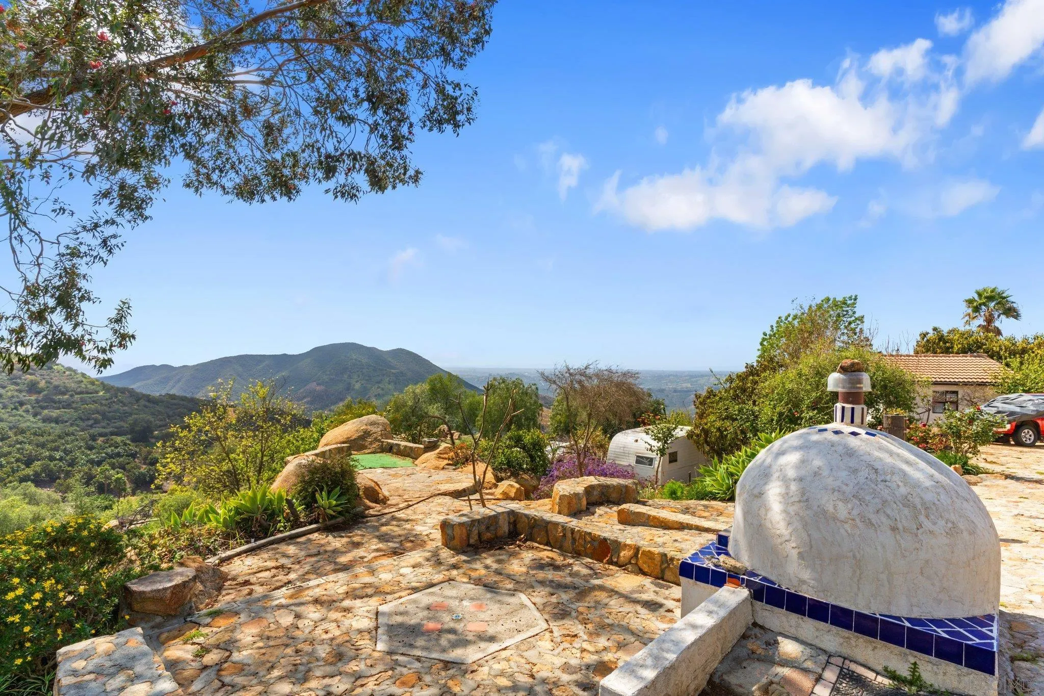9202 Moon Ridge Road Fallbrook, CA 92028 - Photo 31 of 44 a view of a backyard with plants and a patio