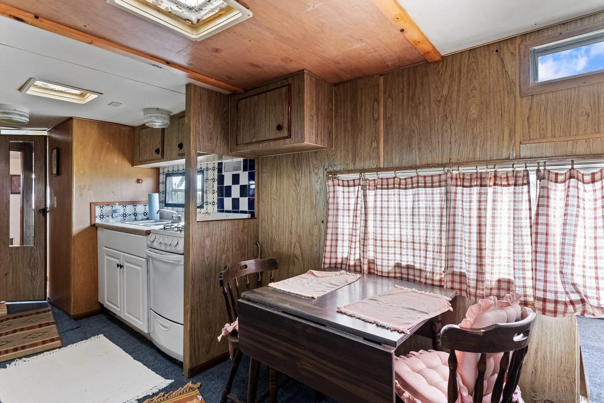 9202 Moon Ridge Road Fallbrook, CA 92028 - Photo 37 of 44 a kitchen with a table chairs stove and cabinets