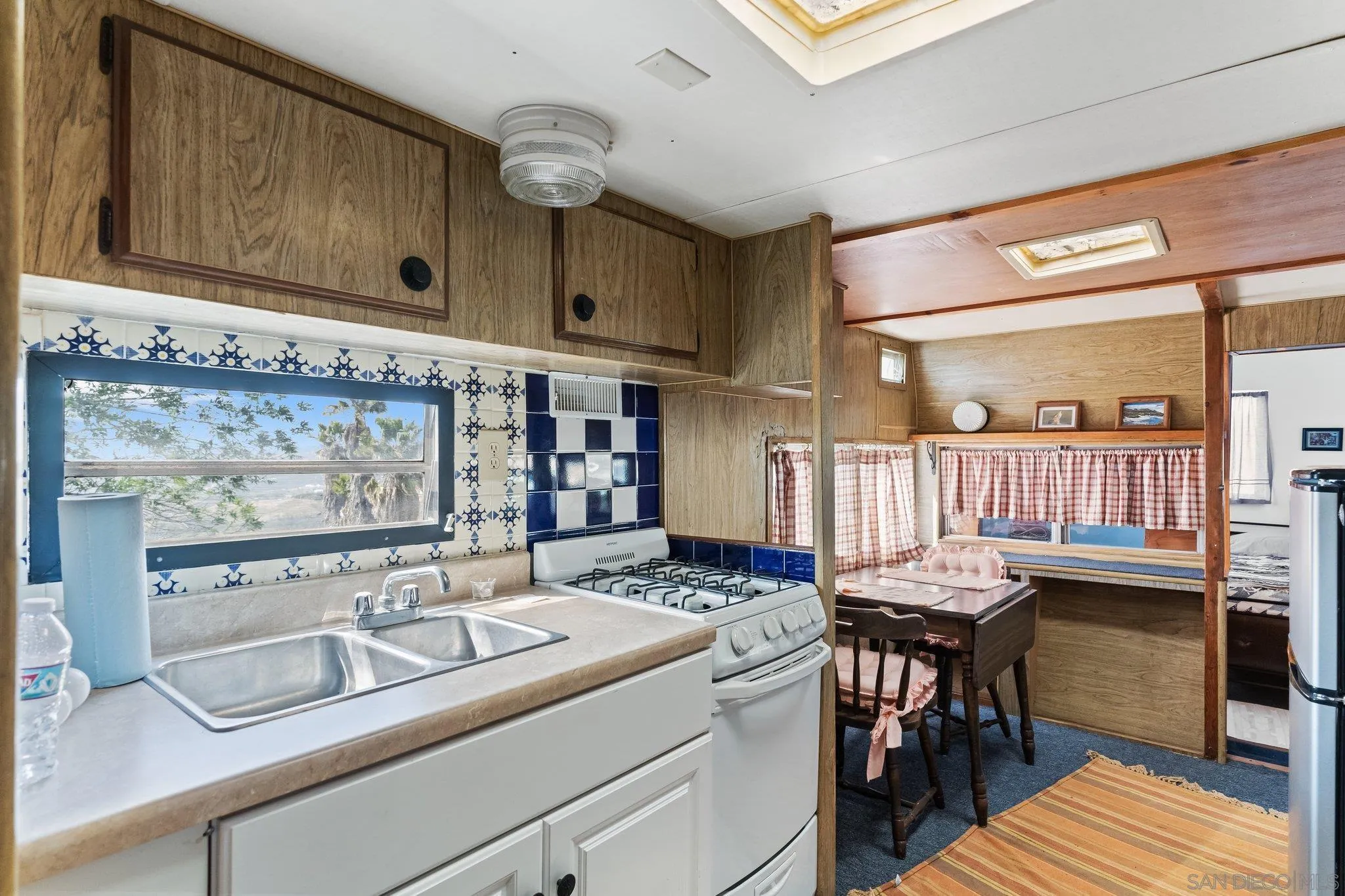 9202 Moon Ridge Road Fallbrook, CA 92028 - Photo 38 of 44 a kitchen with a sink cabinets and wooden floor