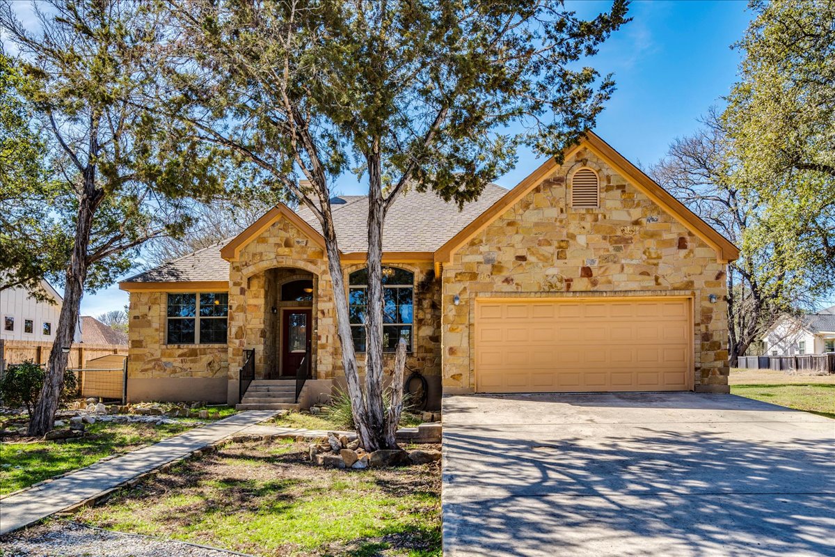 11 Rhapsody Lane Wimberley, TX 78676 - Photo 2 of 35 a front view of a house with garden