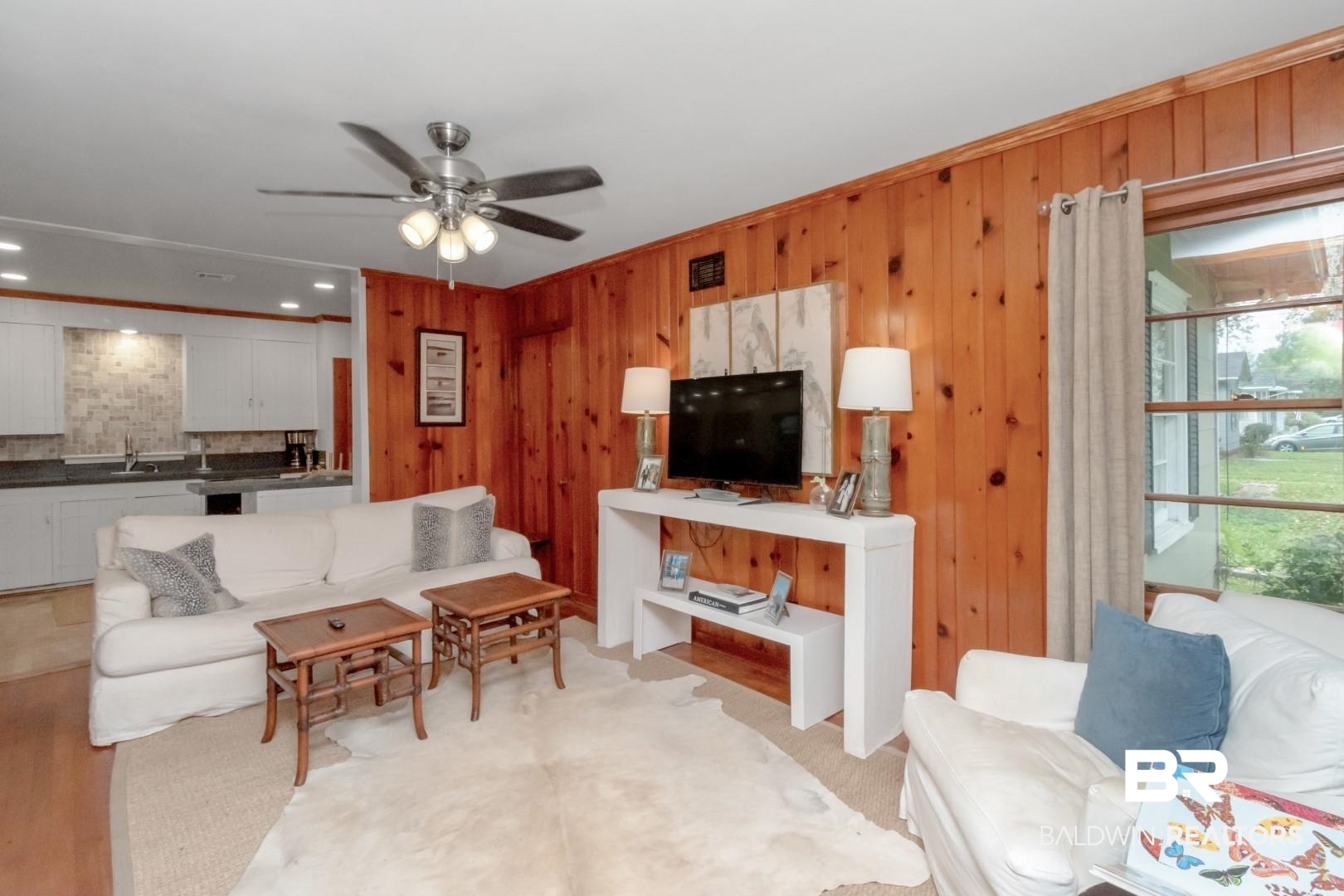 20 Kirby Street Mobile, AL 36607 - Photo 2 of 35 Living room featuring ceiling fan, wooden walls, and sink