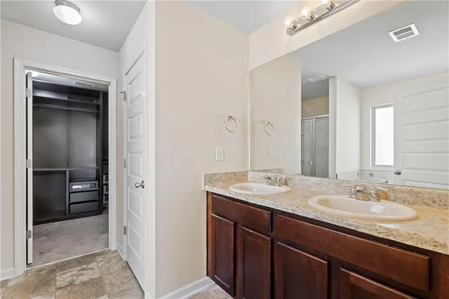 a bathroom with a sink double vanity and a shower