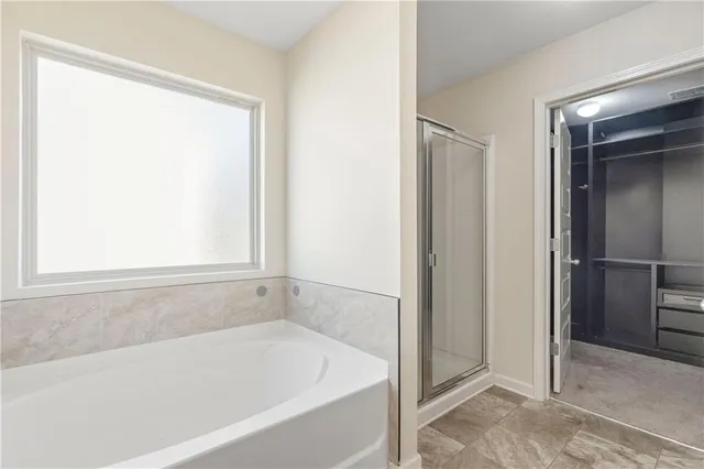 a white bath tub sitting next to a shower