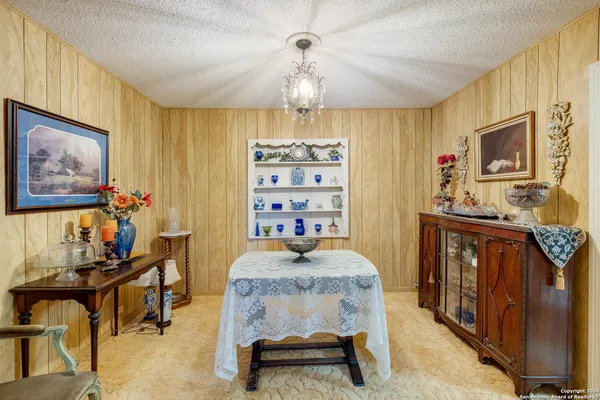 a bedroom with furniture and a chandelier