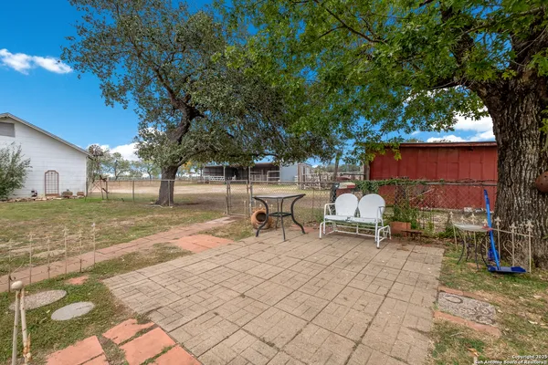 a backyard of a house with table and chairs