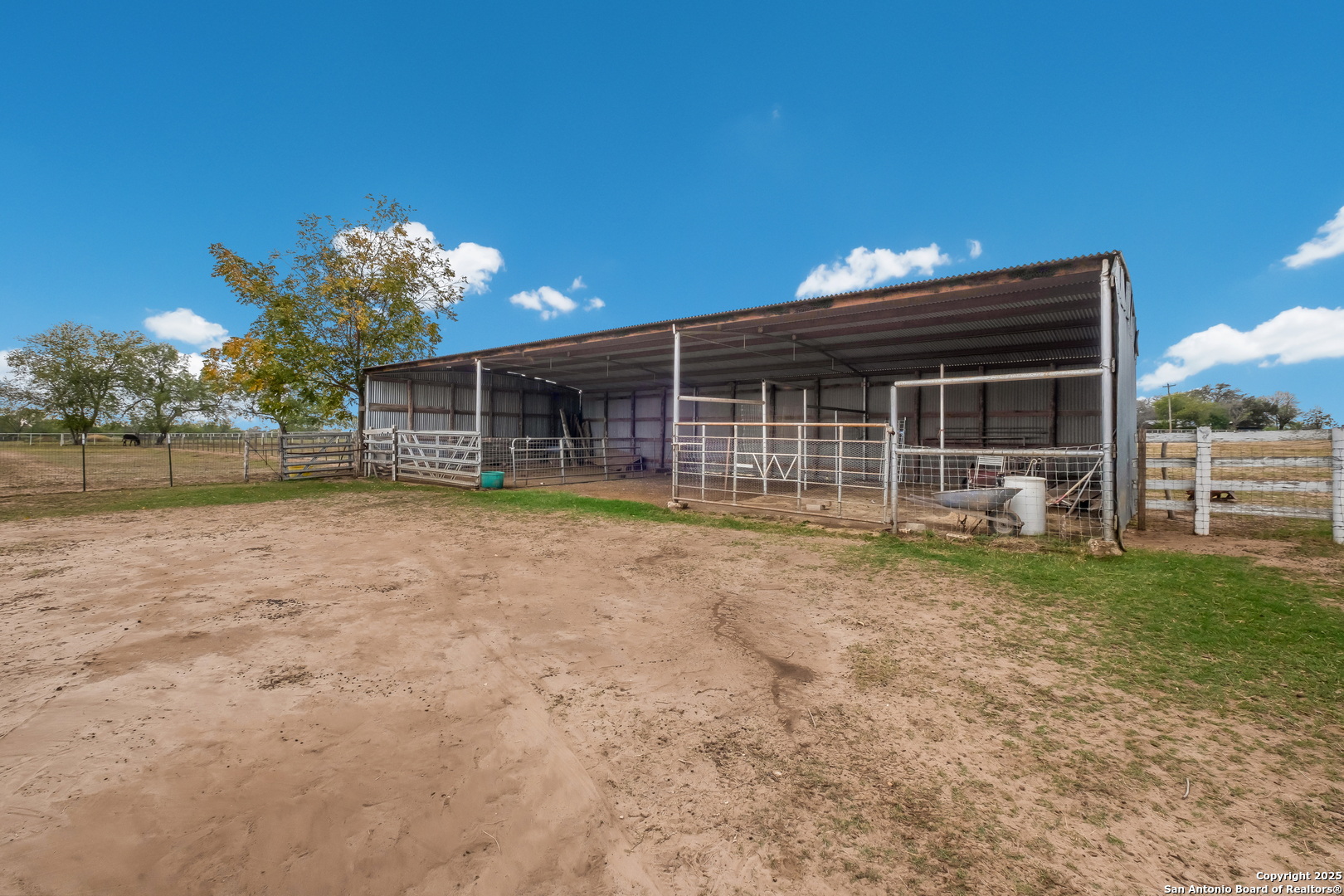461 Highway 173 Devine, TX 78016 - Photo 23 of 27 a view of a house with a backyard and a patio