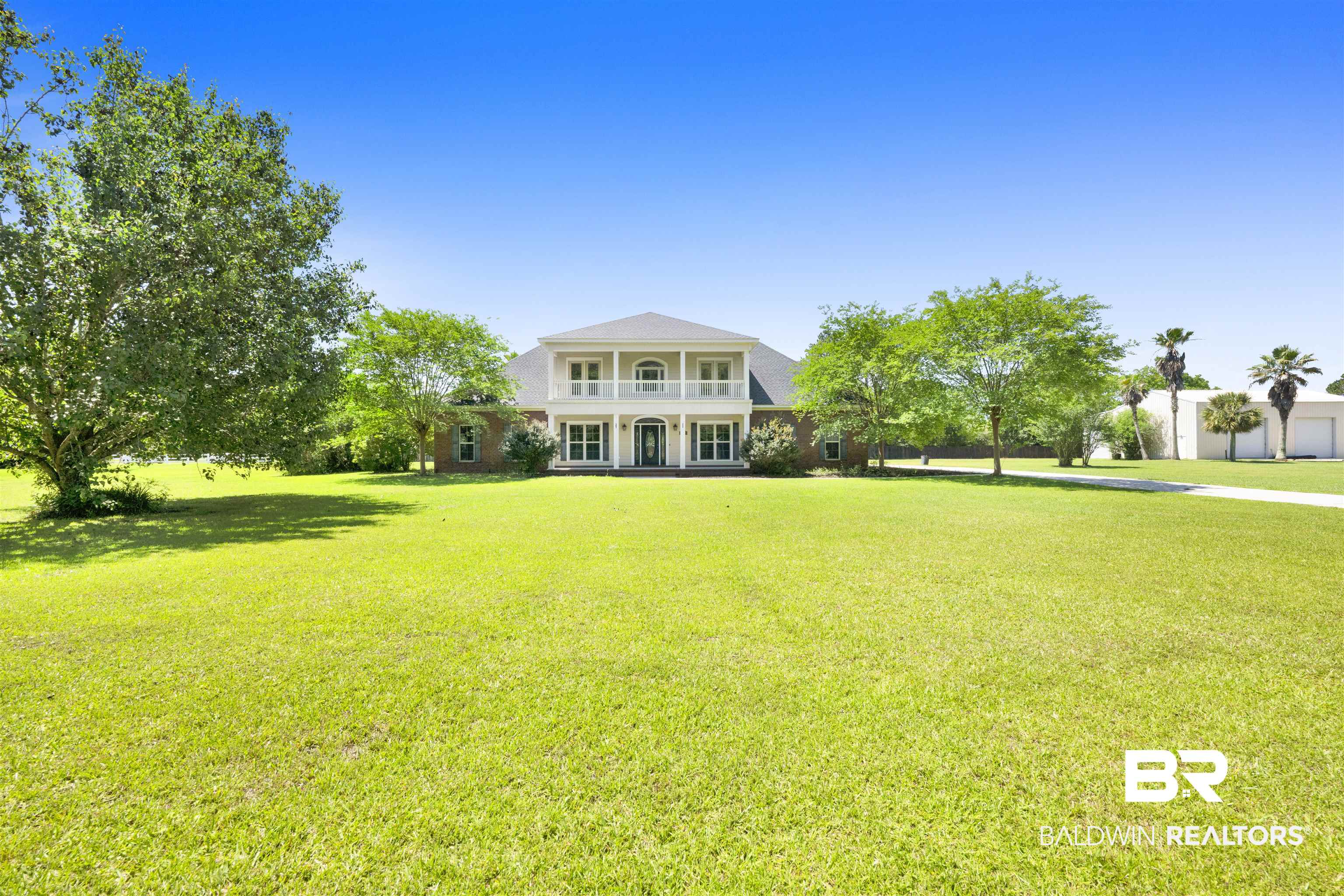 12944 Anna's Way Stapleton, AL 36578 - Photo 14 of 64 Two-story residence featuring a classic facade with a full-width upper balcony and lower porch, supported by white columns