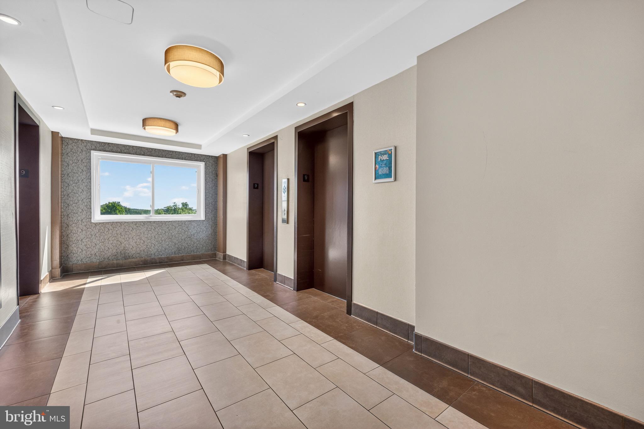 1121 University Boulevard West, Unit 912B Silver Spring, MD 20902 - Photo 26 of 29 Elevators lobby on 9th floor
