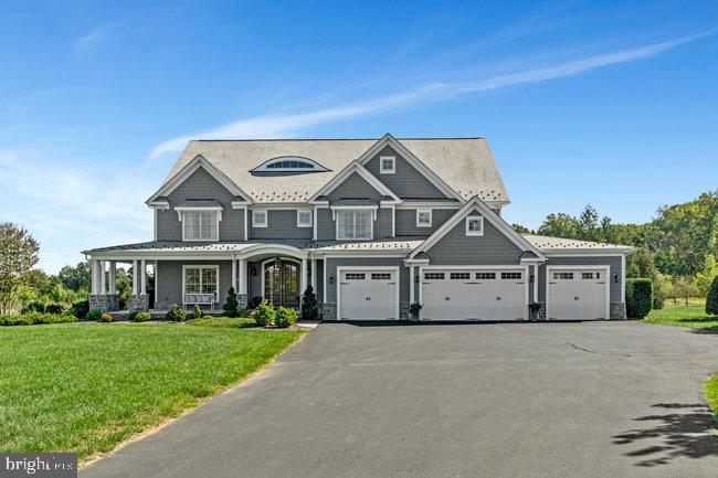 41865 Scotchbridge Place Ashburn, VA 20148 - Photo 15 of 93 a front view of a house with a garden and plants
