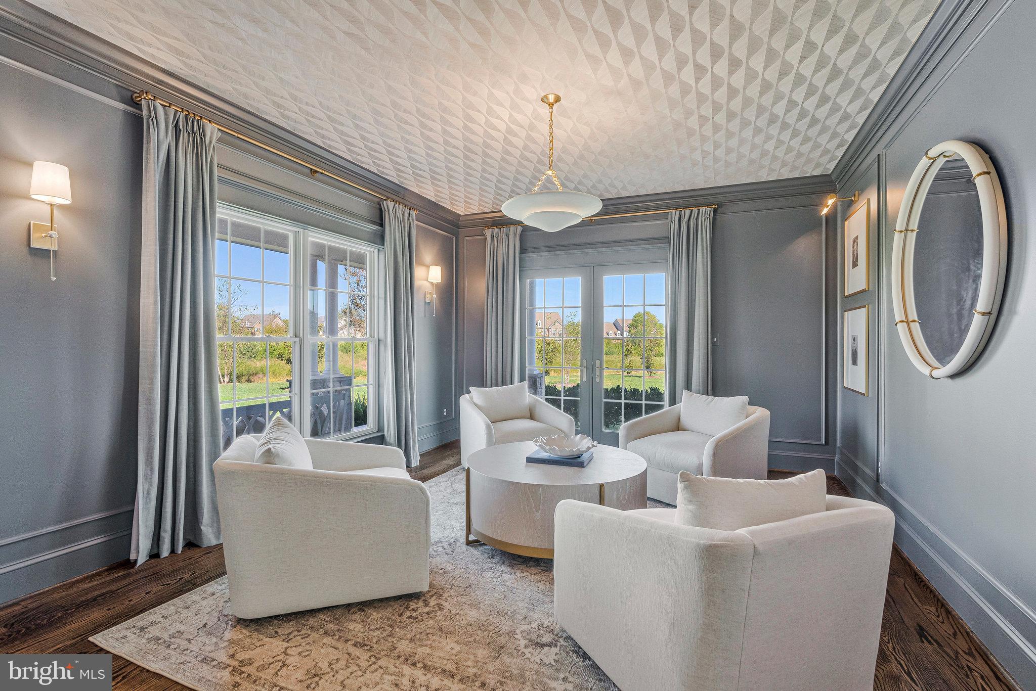 41865 Scotchbridge Place Ashburn, VA 20148 - Photo 20 of 93 a living room with furniture a chandelier and a large window