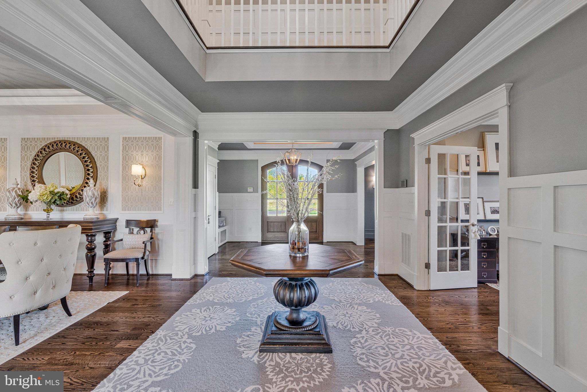 41865 Scotchbridge Place Ashburn, VA 20148 - Photo 28 of 93 a living room with furniture a wooden floor and a table