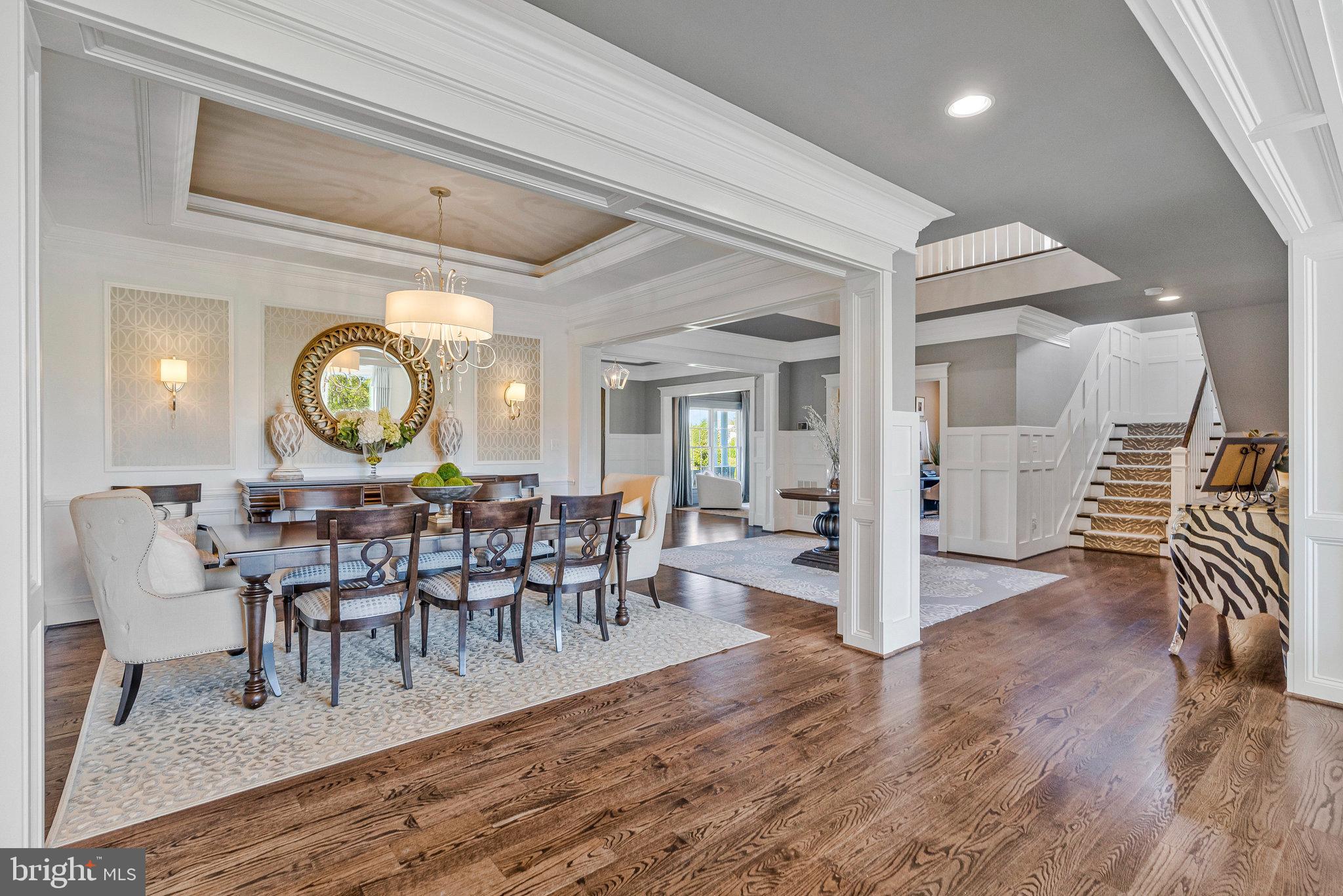 41865 Scotchbridge Place Ashburn, VA 20148 - Photo 29 of 93 a view of a dining room and livingroom with furniture wooden floor and a clock