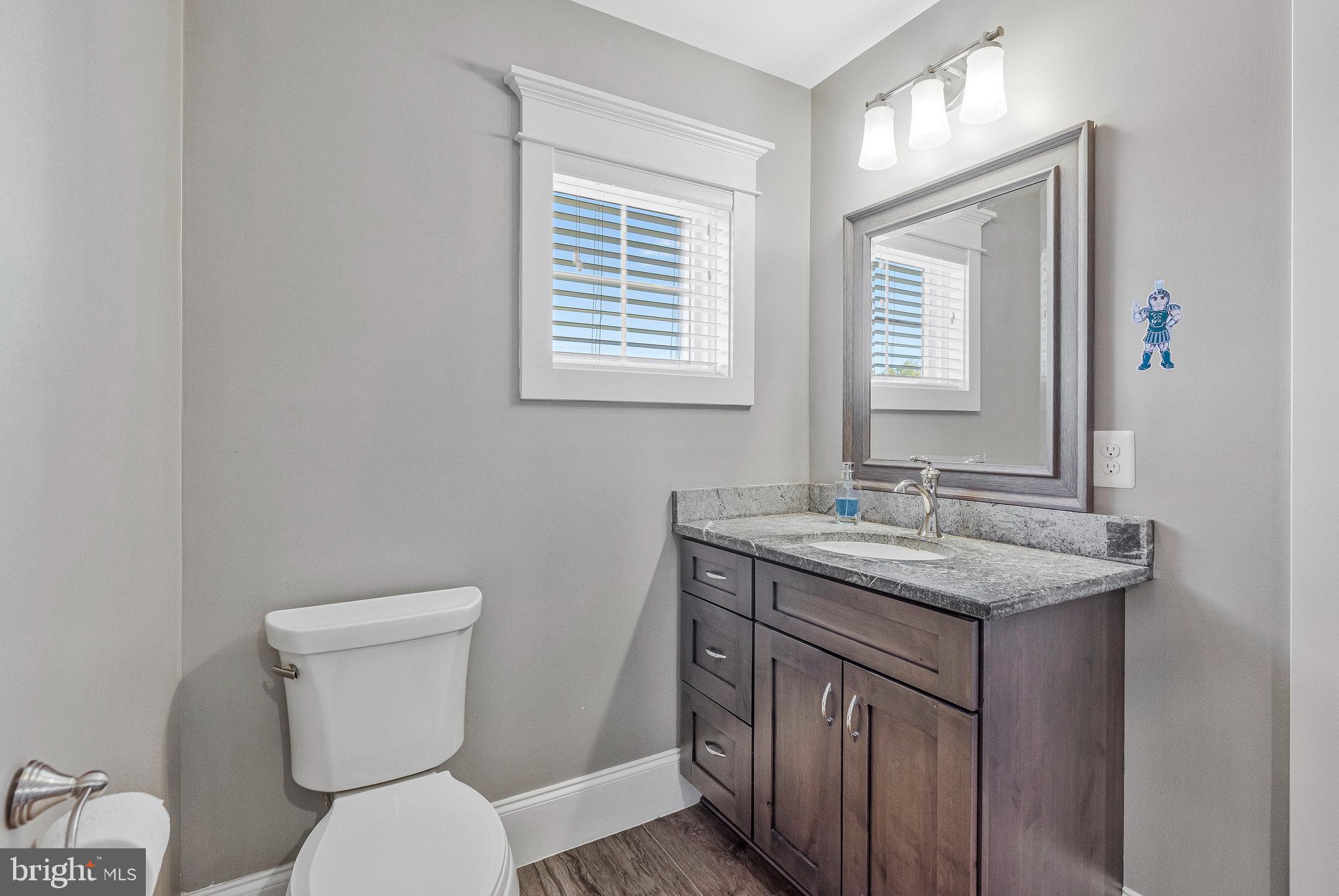 41865 Scotchbridge Place Ashburn, VA 20148 - Photo 59 of 93 a bathroom with a granite countertop toilet a sink and a window