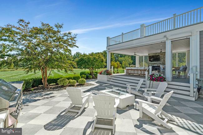 41865 Scotchbridge Place Ashburn, VA 20148 - Photo 75 of 93 a view of a patio with table and chairs potted plants and large tree
