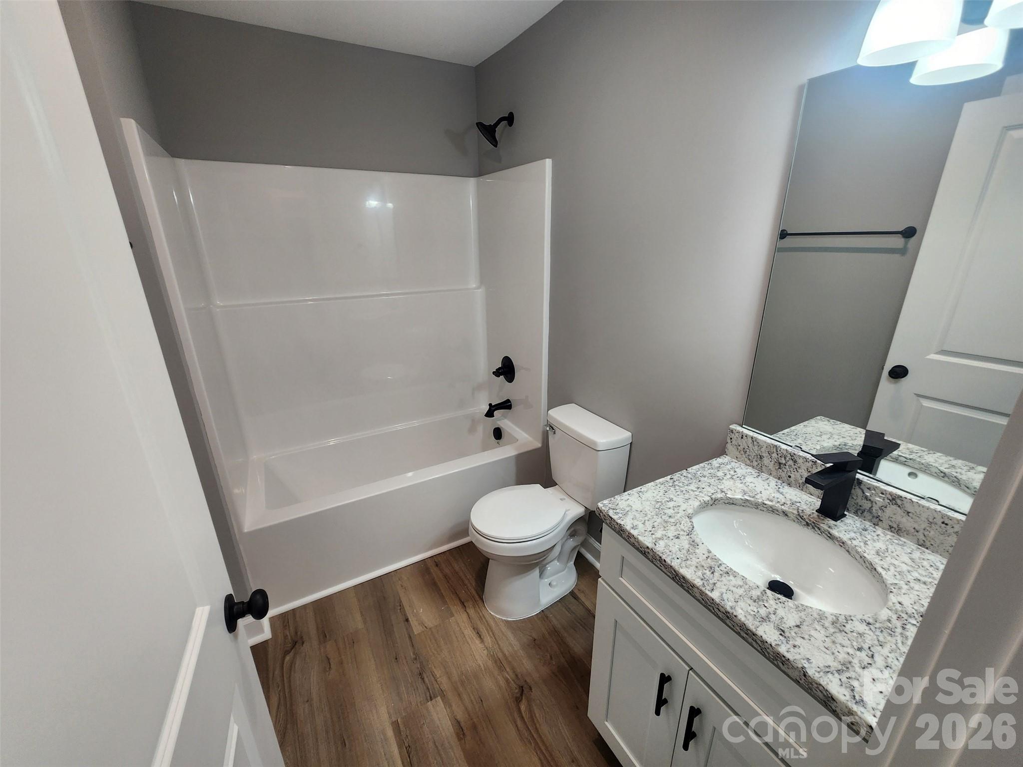 450 East Ridge Road Salisbury, NC 28144 - Photo 11 of 11 a bathroom with a granite countertop sink toilet and shower