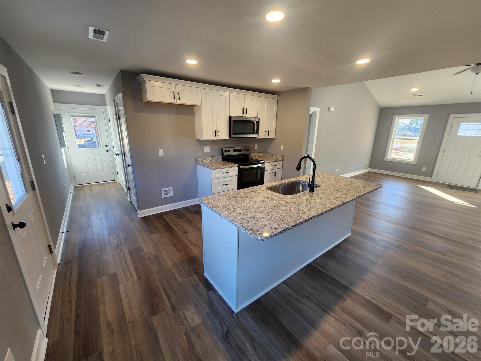 450 East Ridge Road Salisbury, NC 28144 - Photo 4 of 11 an open kitchen with wooden floor and large window
