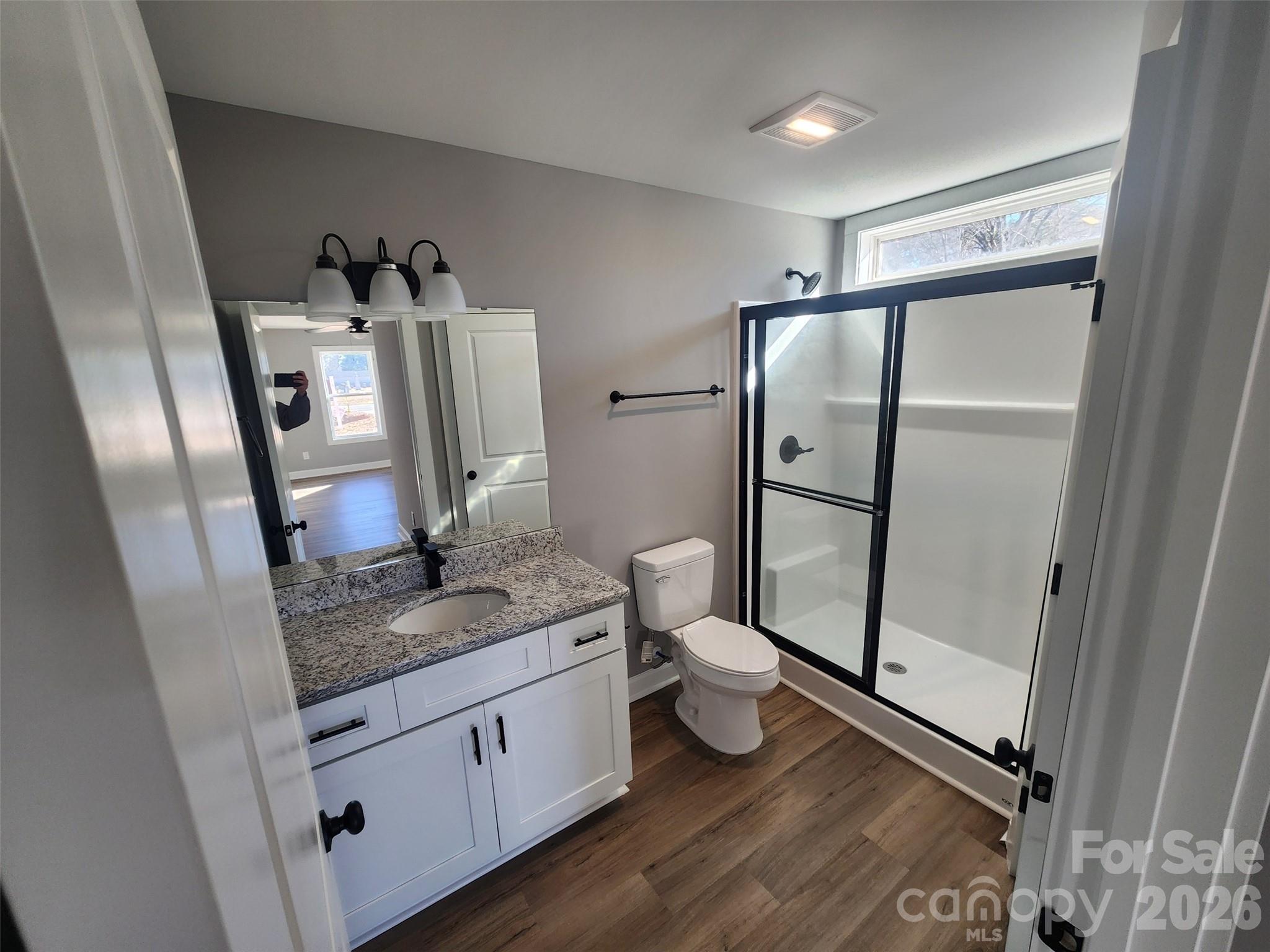 450 East Ridge Road Salisbury, NC 28144 - Photo 7 of 11 a bathroom with a granite countertop sink toilet and shower