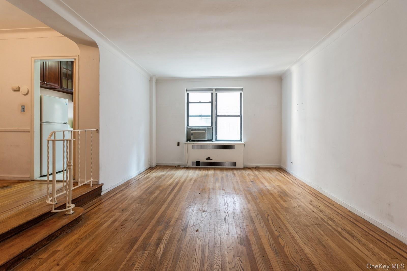 405 West 57th Street, Unit 4C Manhattan, NY 10019 - Photo 12 of 15 an empty room with wooden floor and windows