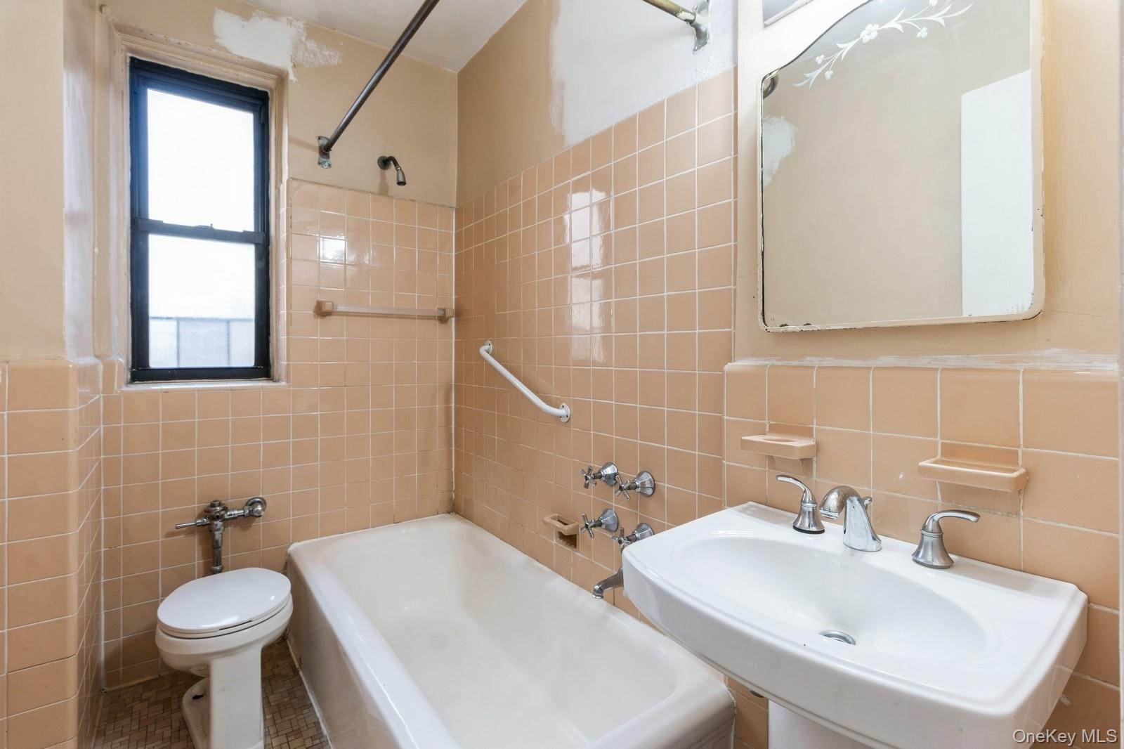 405 West 57th Street, Unit 4C Manhattan, NY 10019 - Photo 6 of 15 a bathroom with a sink toilet and mirror