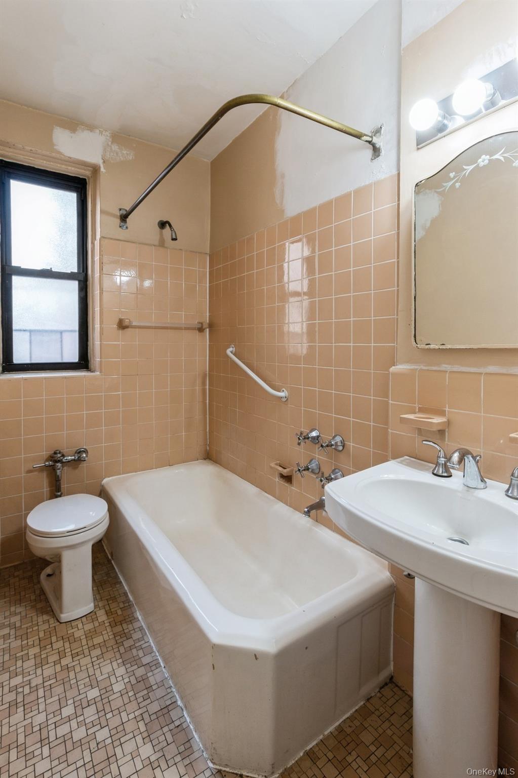 405 West 57th Street, Unit 4C Manhattan, NY 10019 - Photo 7 of 15 a bathroom with a sink a toilet and a mirror
