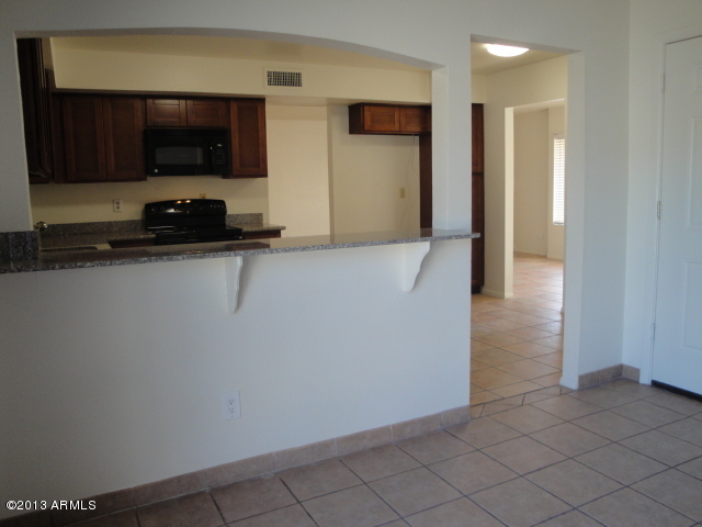 4234 East Apollo Road Phoenix, AZ 85042 - Photo 8 of 33 Bar, kitchen thru to DR from FR