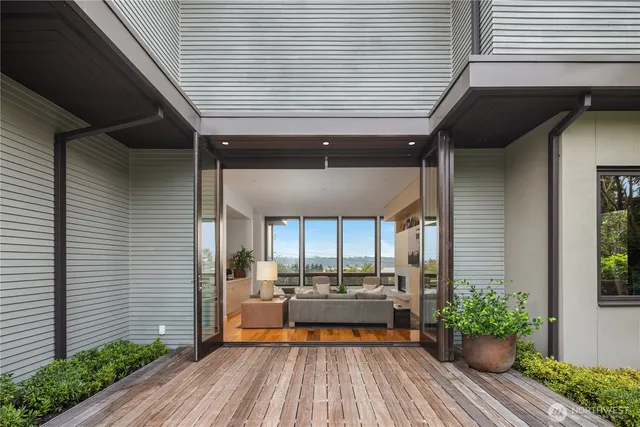 a view of a balcony with chairs and wooden floor