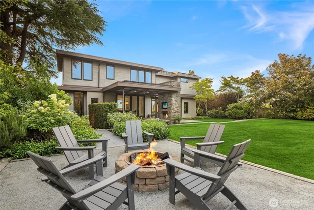 a view of a house with a yard and sitting area