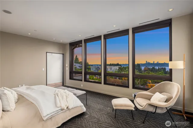 a bedroom with a bed and a large window