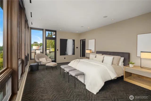 a spacious bedroom with a bed and a large window