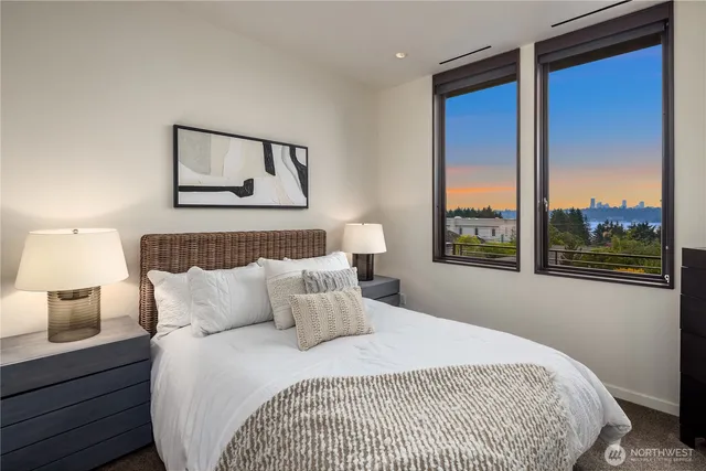 a bedroom with a large bed and a night stand