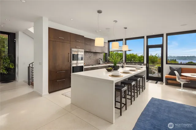 a kitchen with stainless steel appliances granite countertop a sink and a refrigerator