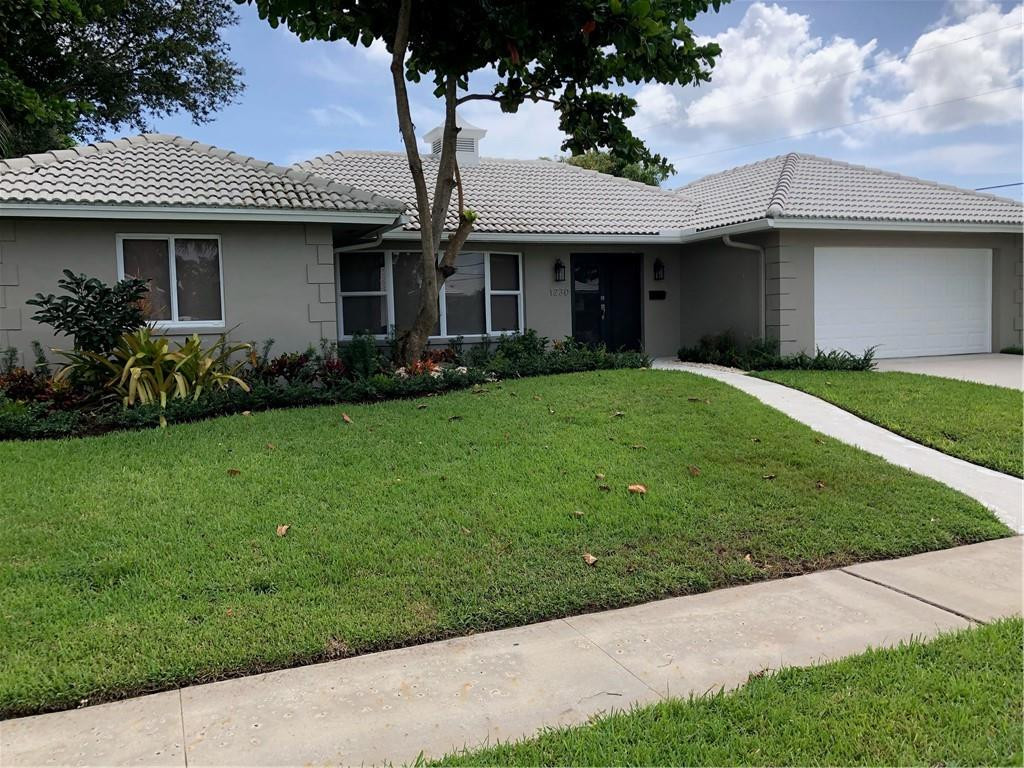 1230 Mulberry Way Boca Raton, FL 33486 - Photo 1 of 31 a front view of a house with a garden