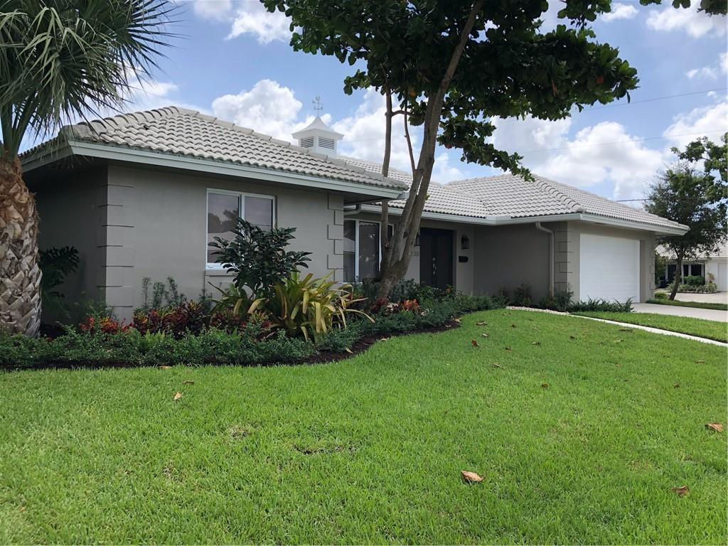 1230 Mulberry Way Boca Raton, FL 33486 - Photo 2 of 31 a front view of a house with a garden